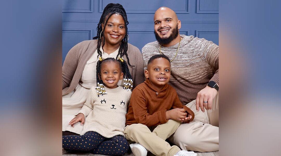 Jenoy Bolden (back left) poses for a professional photo with her husband (back right), daughter (front left) and son (front right).