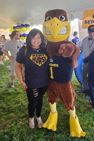 Shenell Hinton poses for a photo with Kent State mascot, Flash, during the 2021 Homecoming tailgate.